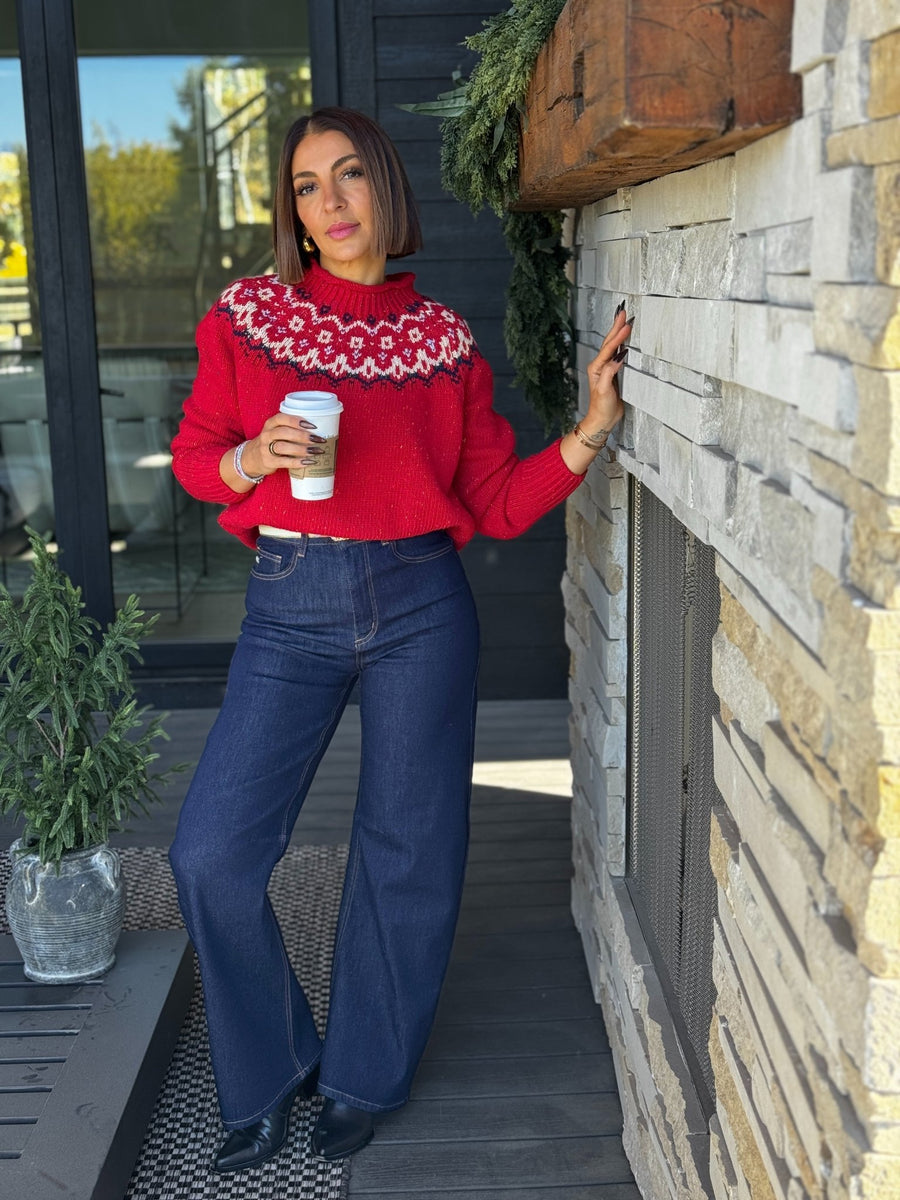 Woman in a Fair Isle sweater with dark jeans and boots